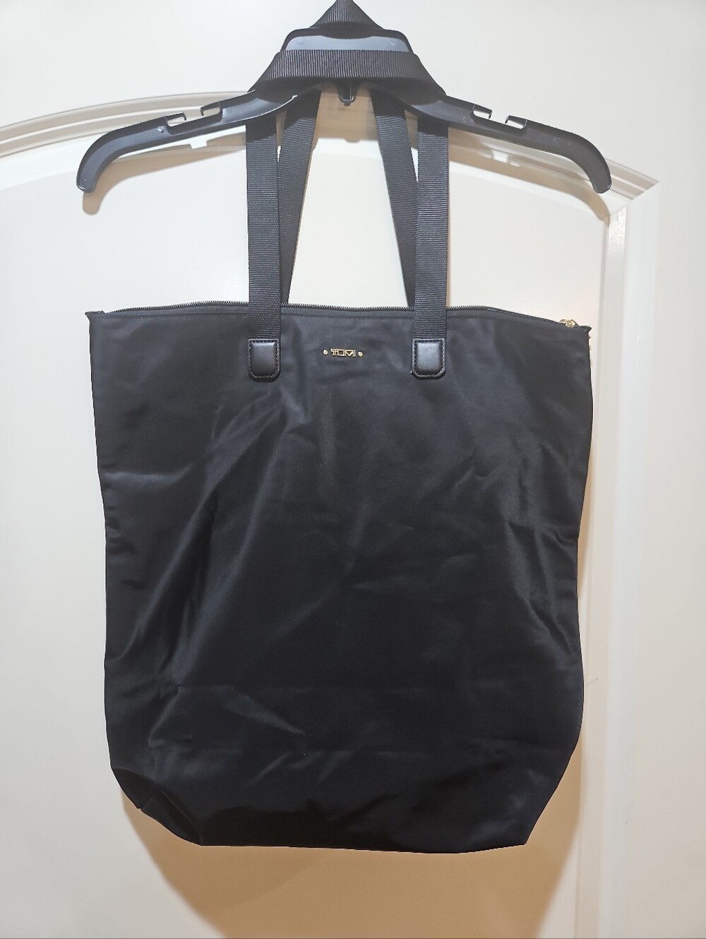 Tumi Black Nylon Tote with Gold-tone Logo And Trolley Sleeve.